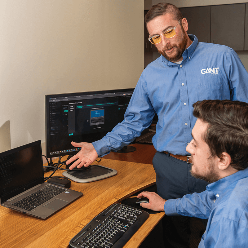 2 IT employees looking at computer